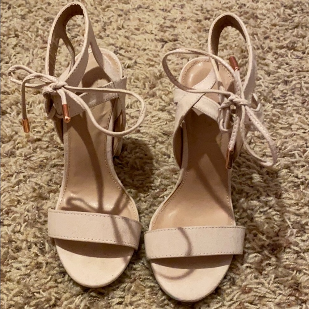 Lace up heels with rose gold tips on the laces.
